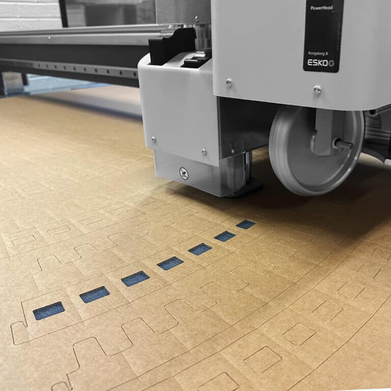 Cardboard cutting and plotting machine